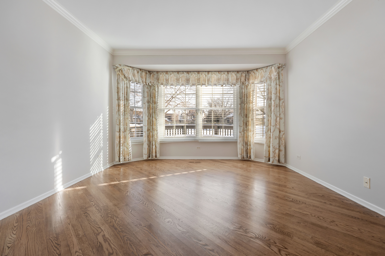 14707 Hollow Tree Road Orland Park, IL 60462 - Photo 24 of 47 a view of an empty room with wooden floor and a window