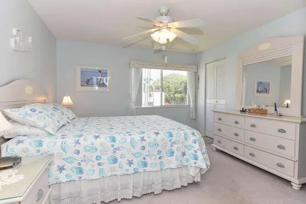 a bedroom with a large bed and a dresser