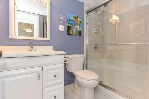 a bathroom with a sink a toilet and shower