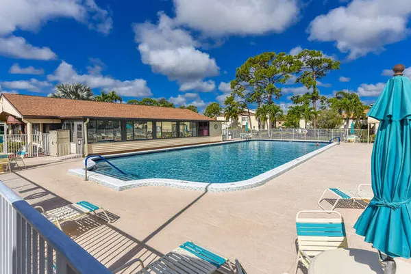 a view of a swimming pool with outdoor seating