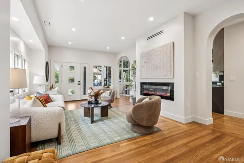 a kitchen with stainless steel appliances granite countertop a sink a stove and a refrigerator