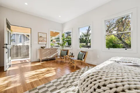 a living room with furniture a lamp and potted plant