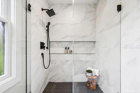 a view of a patio with table and chairs potted plants and palm tree