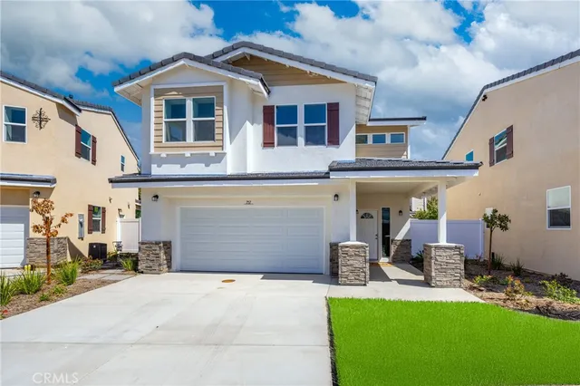 a front view of a house with a yard garage and glass door