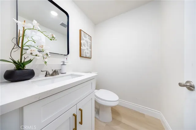 a bathroom with a sink a toilet and mirror