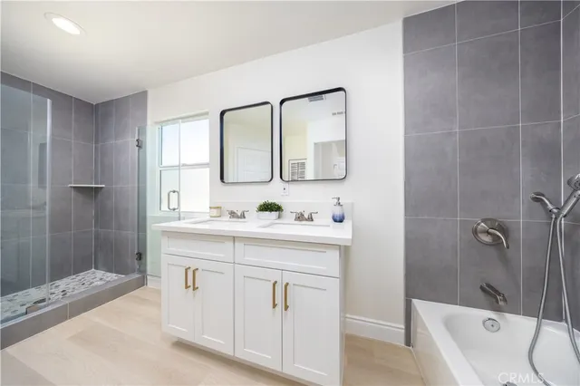 a bathroom with a granite countertop sink a toilet and shower