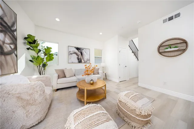 a living room with furniture and a potted plant