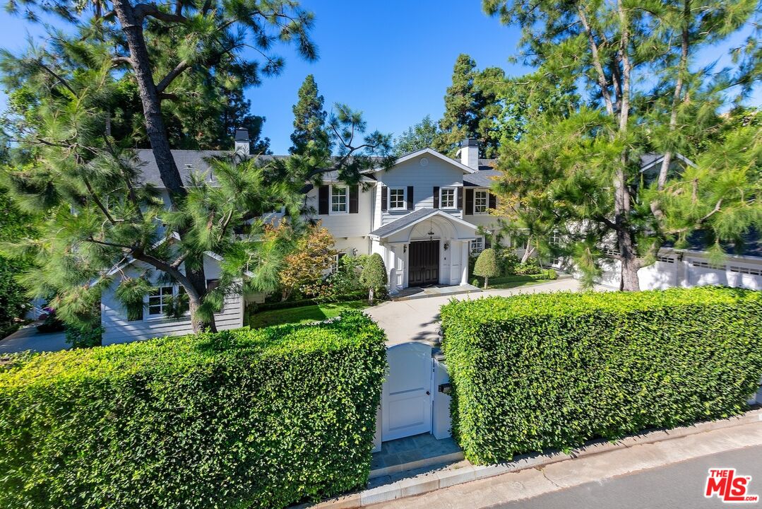 655 North Faring Road Los Angeles, CA 90077 - Photo 5 of 26 a front view of a house with a yard