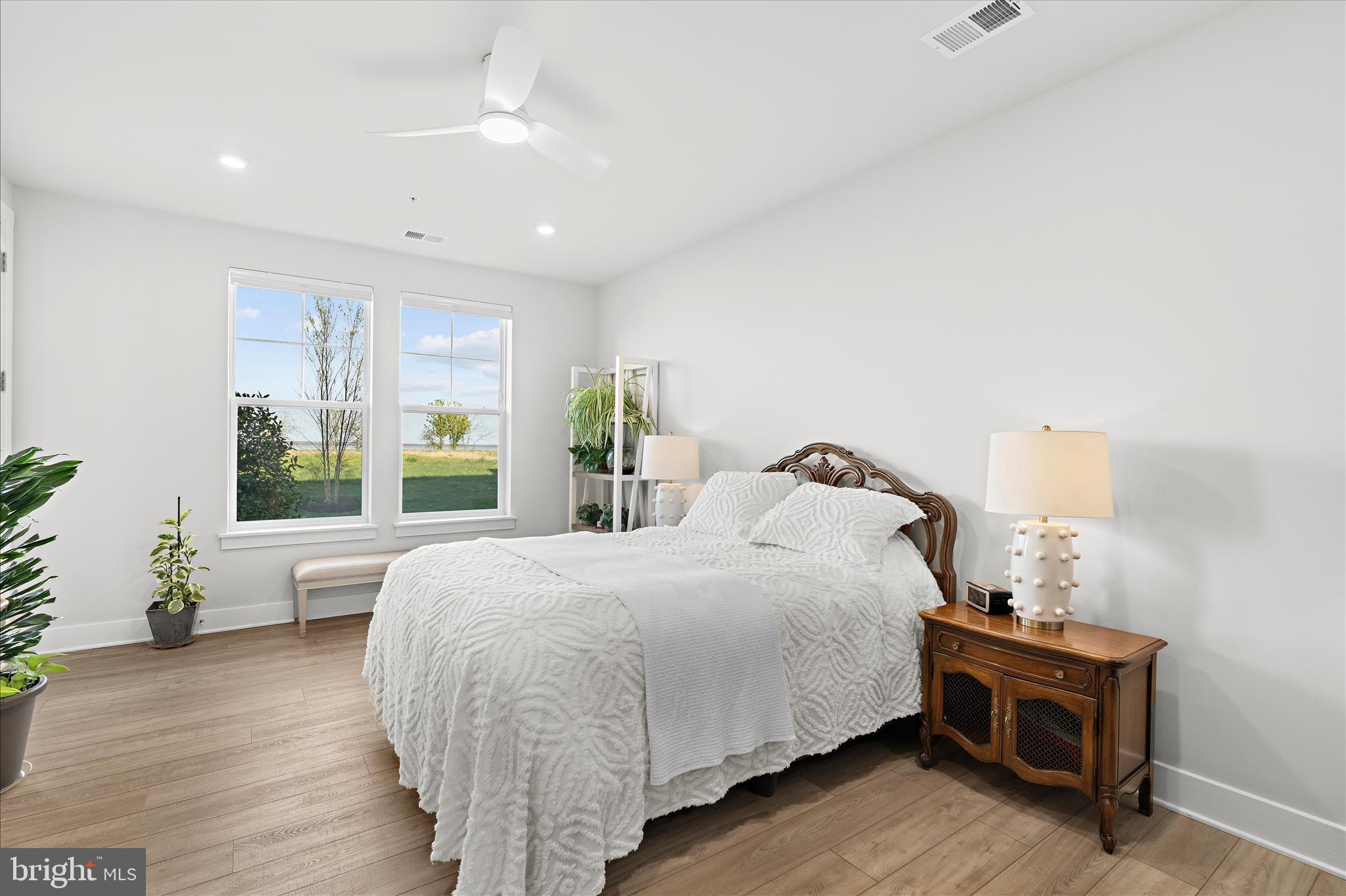 132 Wheelhouse Way, Unit 11 Chester, MD 21619 - Photo 14 of 77 a bedroom with a bed and wooden floor