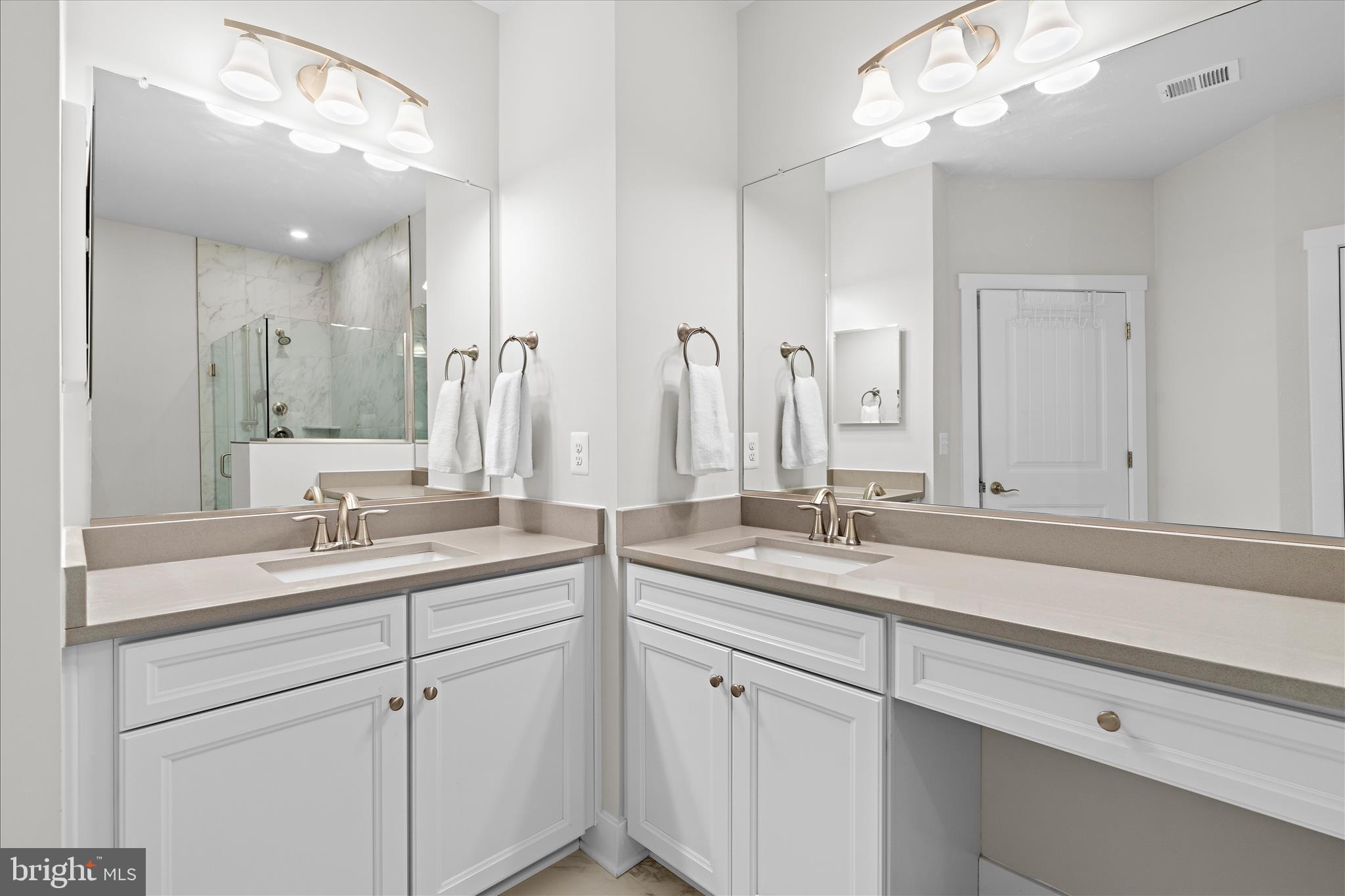 132 Wheelhouse Way, Unit 11 Chester, MD 21619 - Photo 16 of 77 a bathroom with a sink a large mirror and vanity