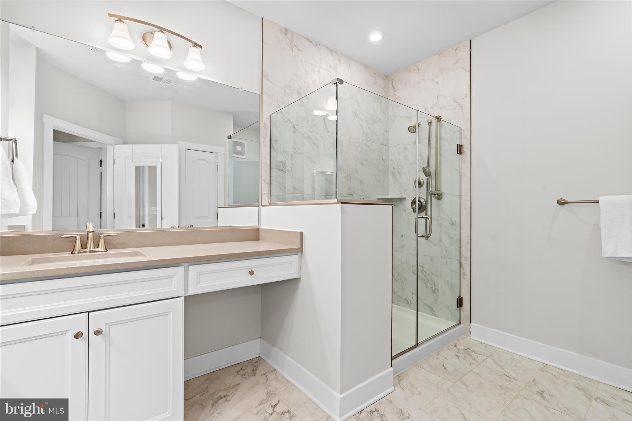 132 Wheelhouse Way, Unit 11 Chester, MD 21619 - Photo 18 of 77 a bathroom with a shower sink and mirror