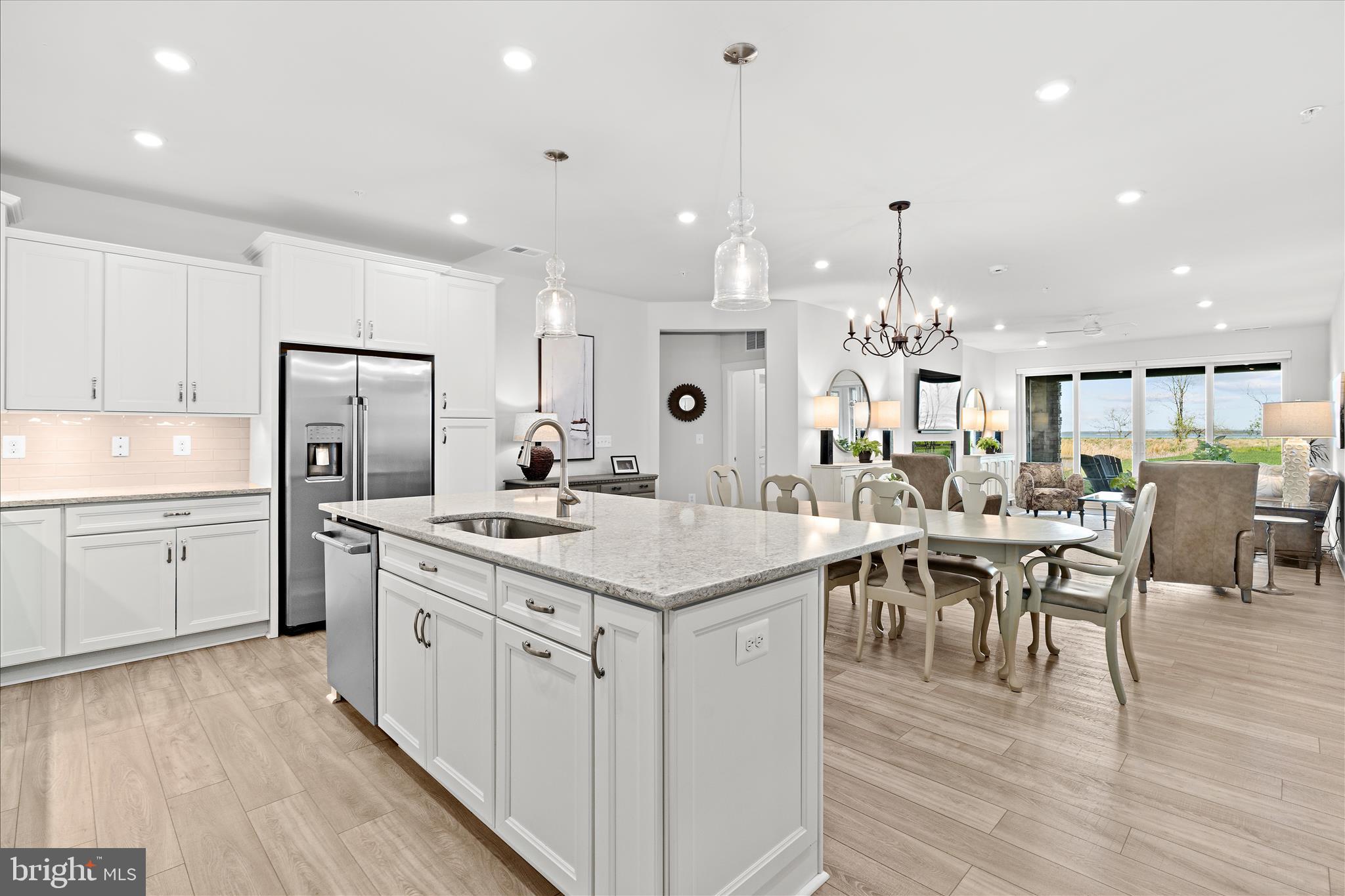 132 Wheelhouse Way, Unit 11 Chester, MD 21619 - Photo 2 of 77 a large kitchen with cabinets chairs and wooden floor