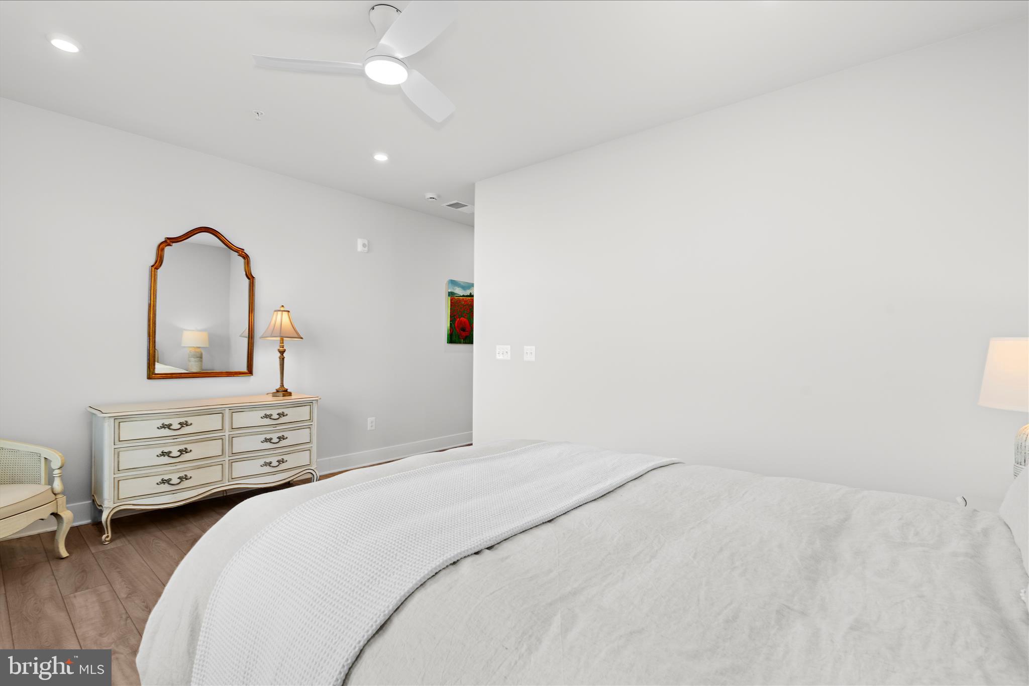 132 Wheelhouse Way, Unit 11 Chester, MD 21619 - Photo 20 of 77 a bedroom with a bed and a dresser