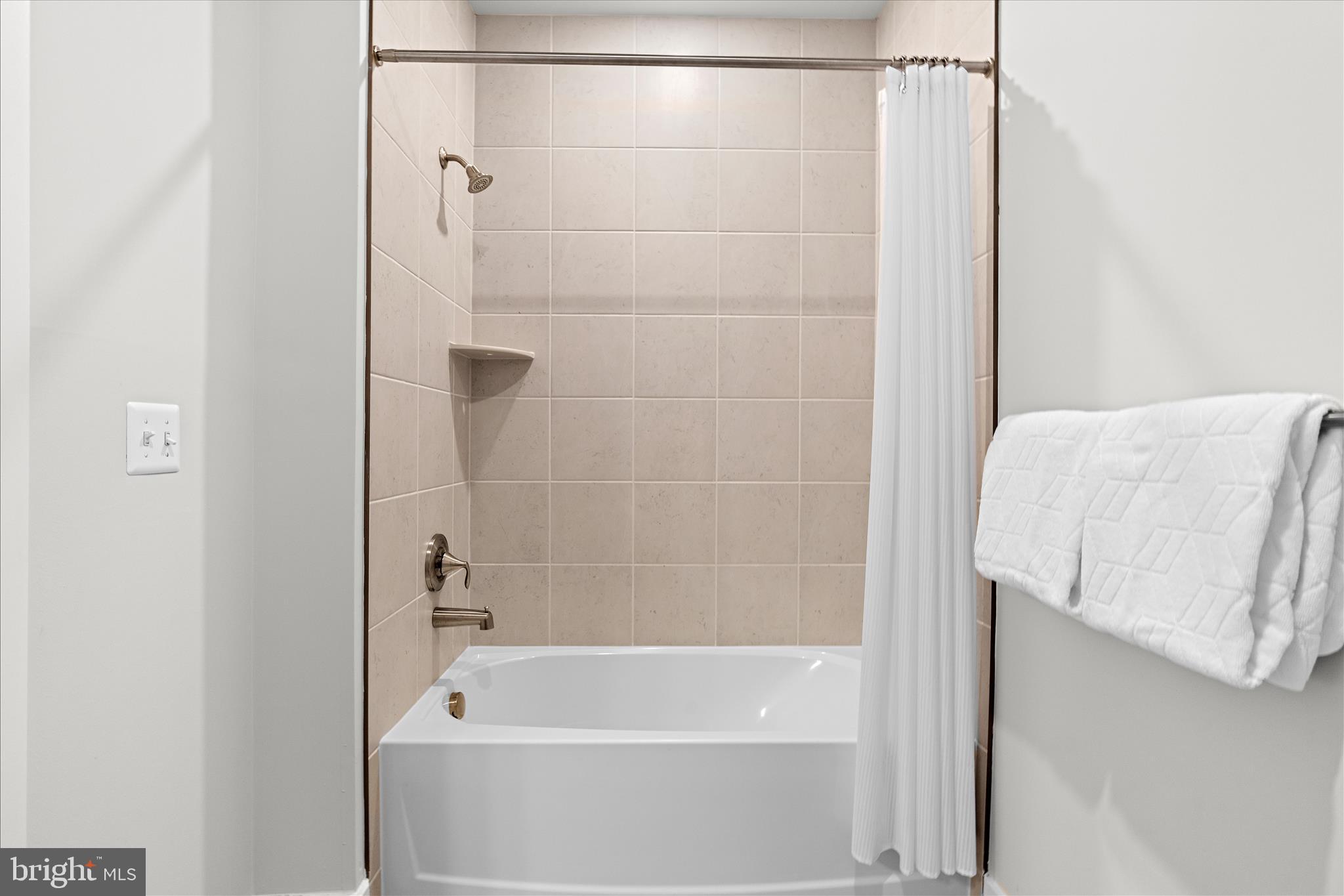 132 Wheelhouse Way, Unit 11 Chester, MD 21619 - Photo 23 of 77 a bathroom with a shower and a bath tub