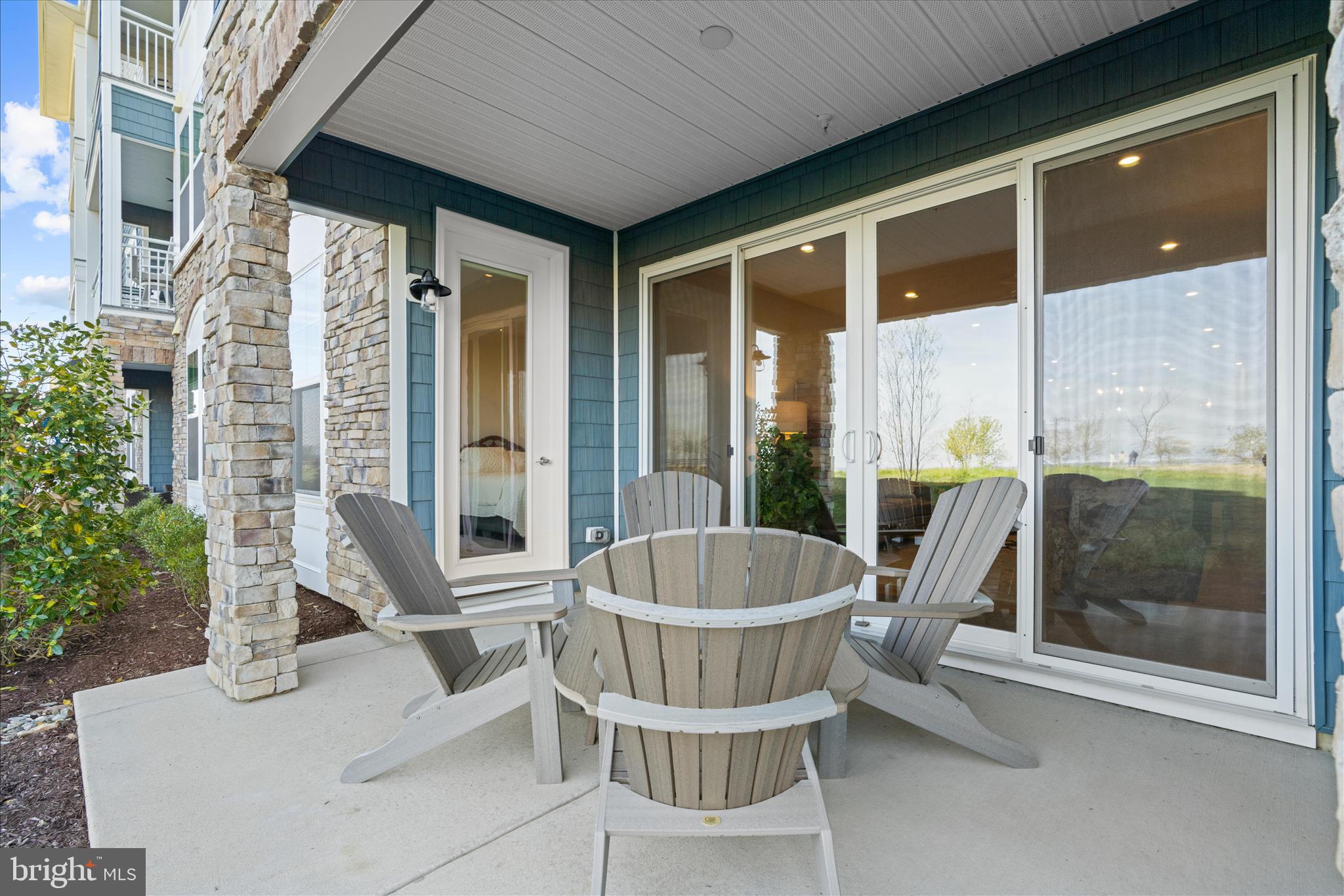 132 Wheelhouse Way, Unit 11 Chester, MD 21619 - Photo 27 of 77 a porch with a table and chairs