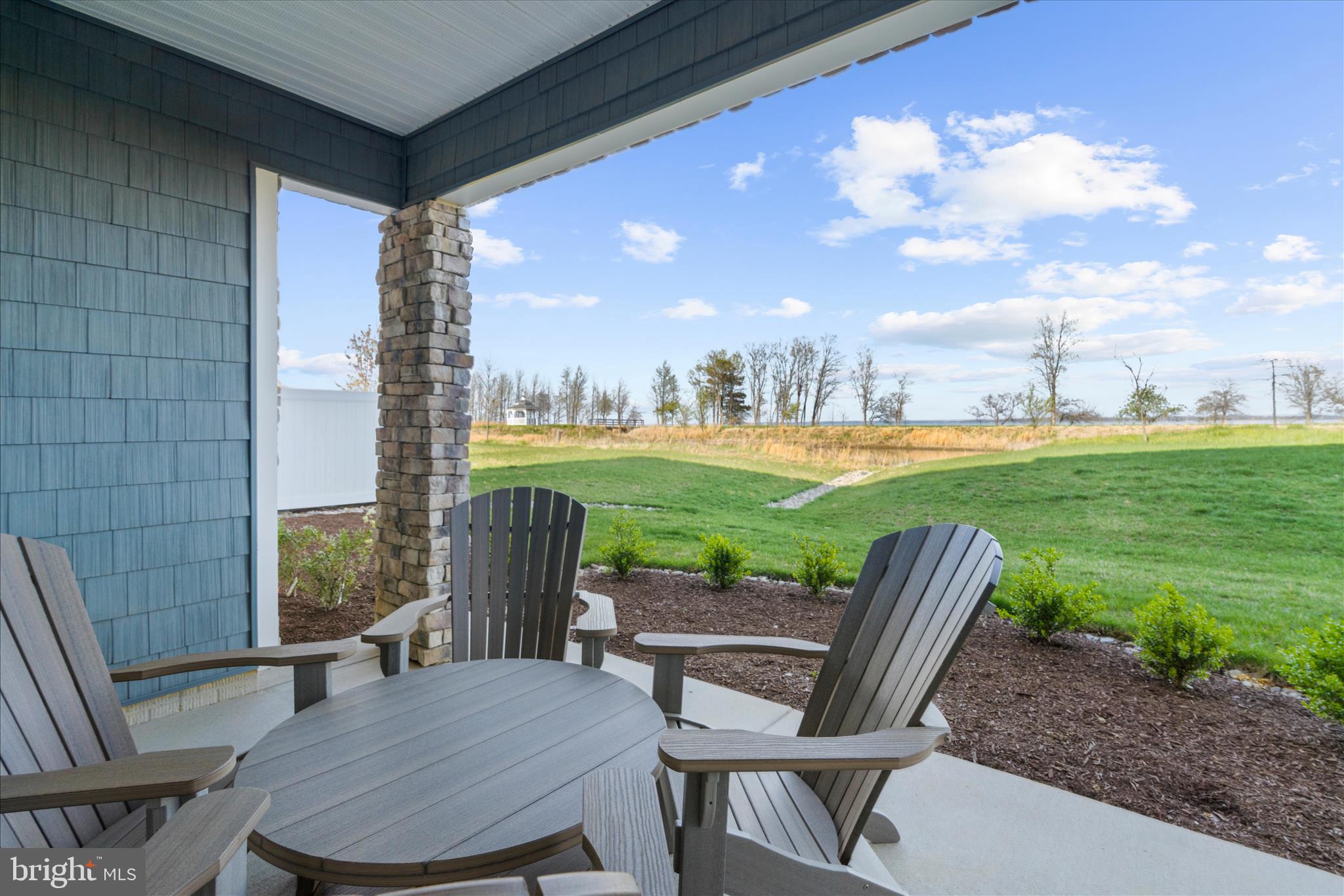 132 Wheelhouse Way, Unit 11 Chester, MD 21619 - Photo 28 of 77 a view of a patio with table and chairs and potted plants