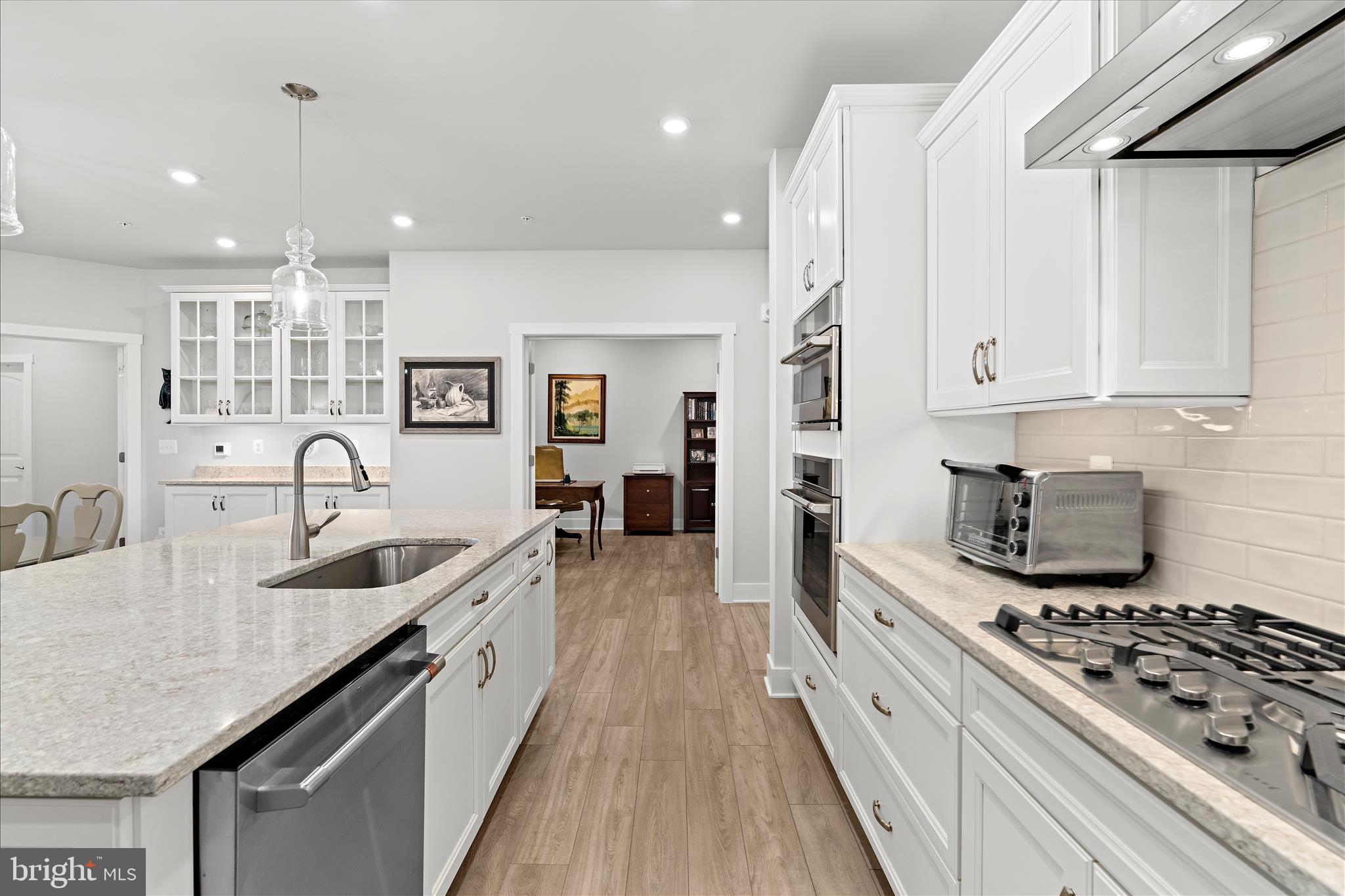 132 Wheelhouse Way, Unit 11 Chester, MD 21619 - Photo 3 of 77 a kitchen with kitchen island granite countertop a sink a counter space and stainless steel appliances