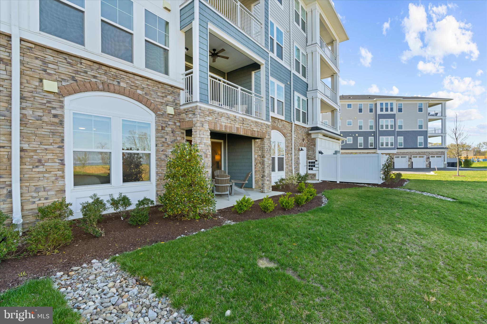 132 Wheelhouse Way, Unit 11 Chester, MD 21619 - Photo 32 of 77 a view of an apartment building with a yard