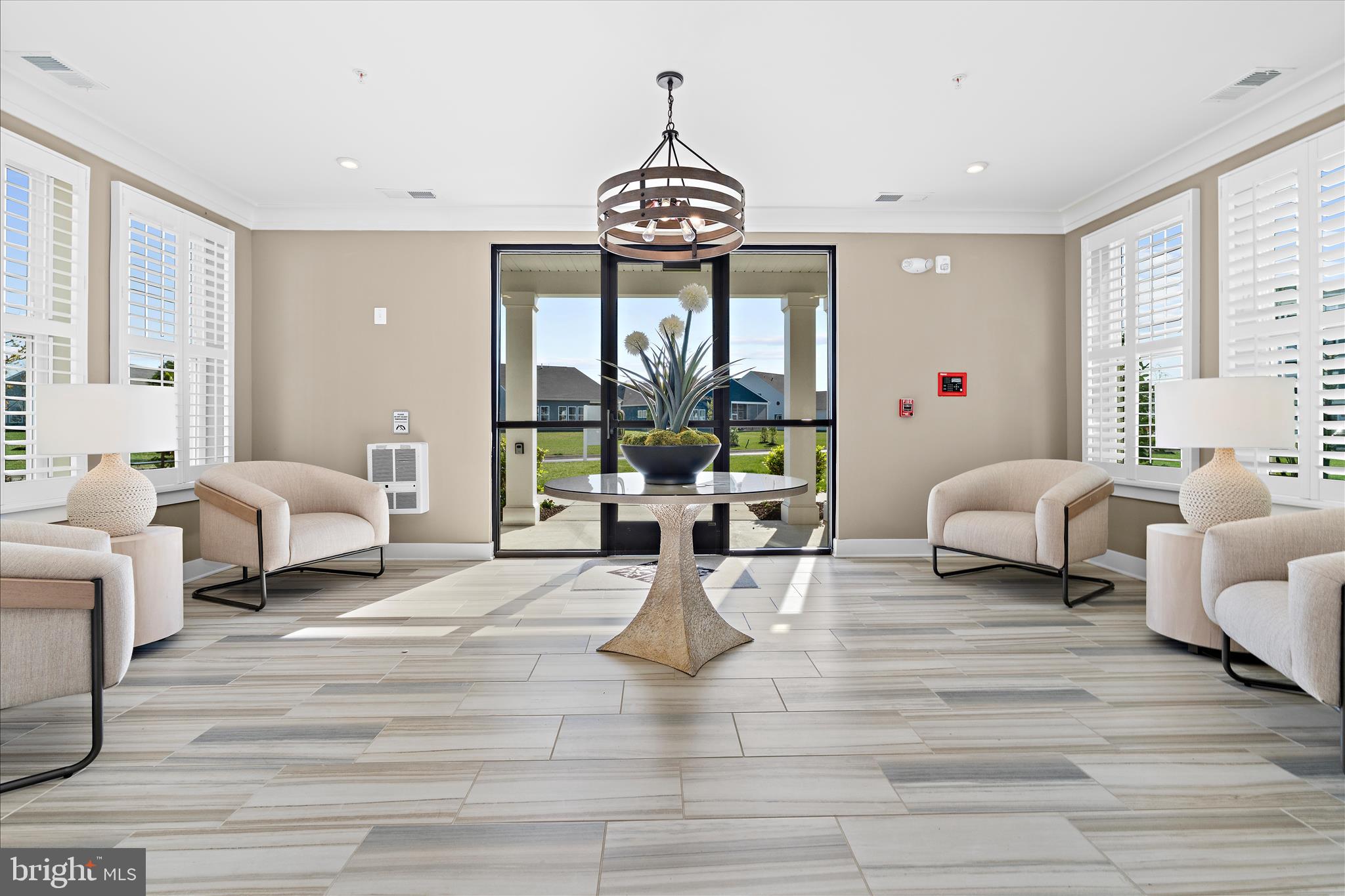 132 Wheelhouse Way, Unit 11 Chester, MD 21619 - Photo 34 of 77 a living room with furniture a chandelier and a window