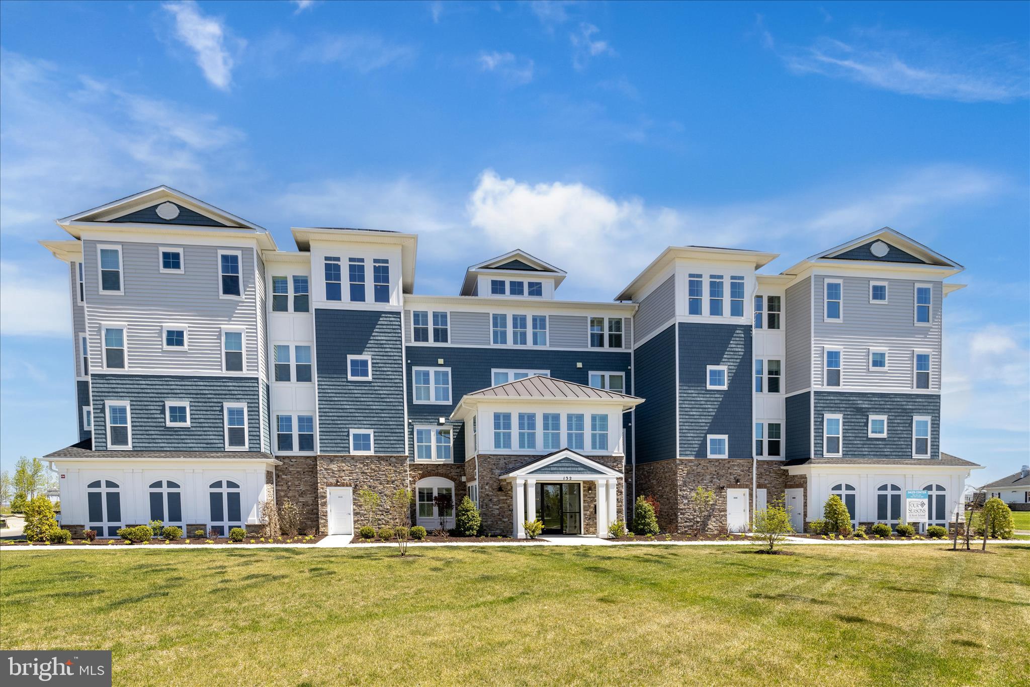 132 Wheelhouse Way, Unit 11 Chester, MD 21619 - Photo 38 of 77 a large building with a big yard and large trees