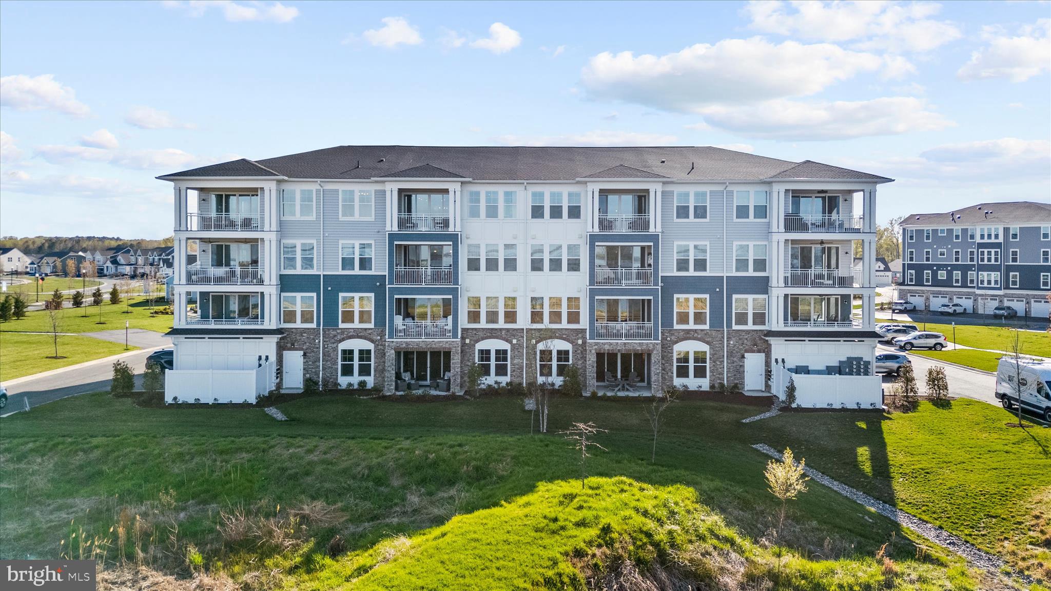 132 Wheelhouse Way, Unit 11 Chester, MD 21619 - Photo 46 of 77 a view of a house with a swimming pool and a yard