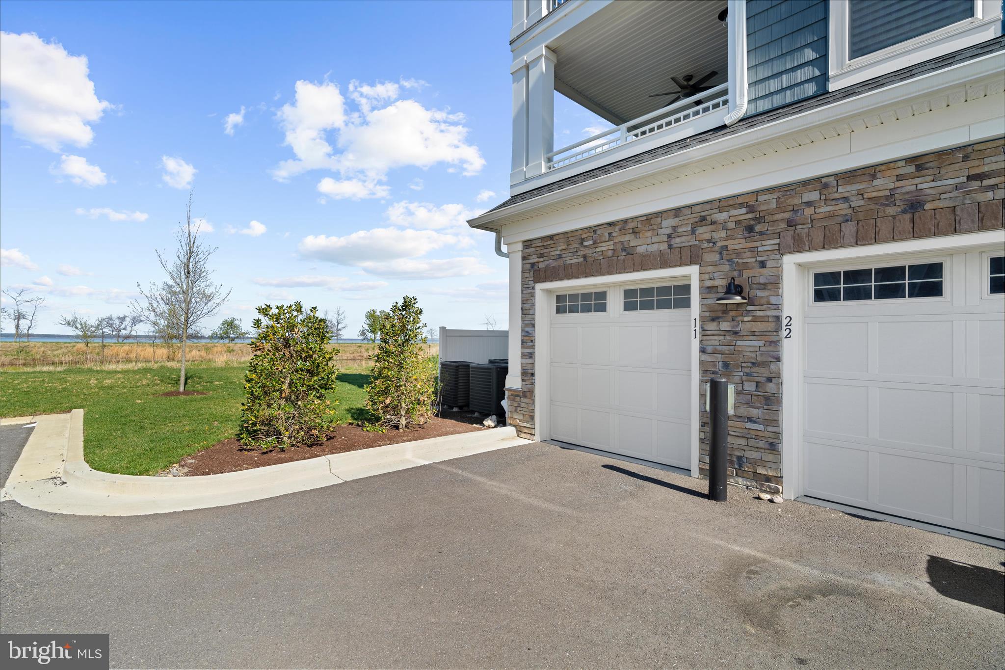 132 Wheelhouse Way, Unit 11 Chester, MD 21619 - Photo 47 of 77 a view of a house with a yard and potted plants