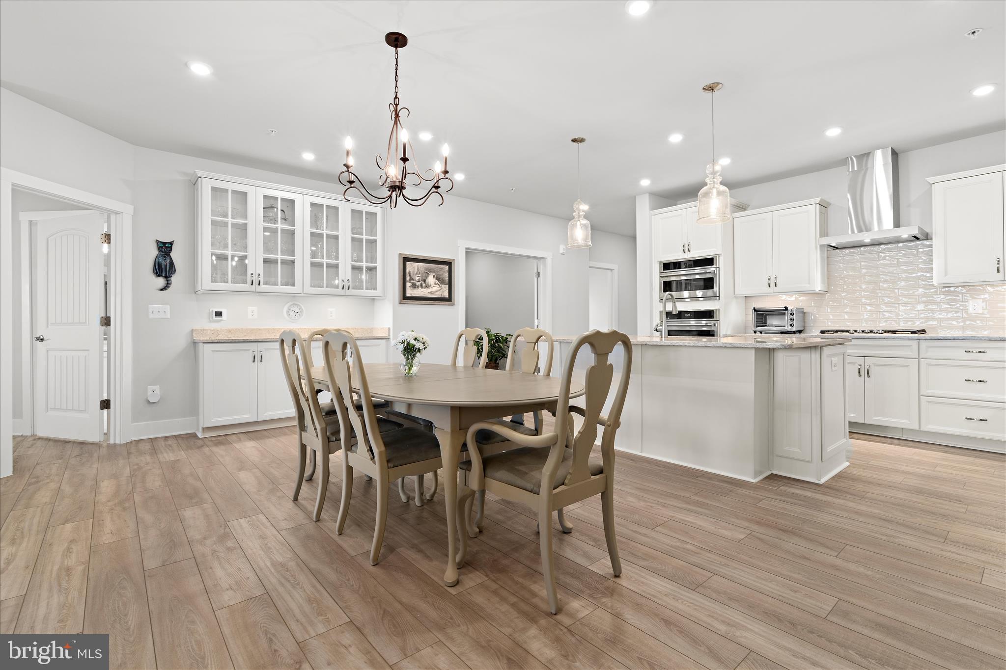 132 Wheelhouse Way, Unit 11 Chester, MD 21619 - Photo 5 of 77 a view of a dining room with furniture and wooden floor
