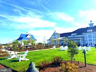 132 Wheelhouse Way, Unit 11 Chester, MD 21619 - Photo 60 of 77 a view of a house with a yard and potted plants
