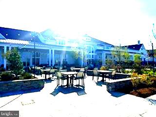 132 Wheelhouse Way, Unit 11 Chester, MD 21619 - Photo 61 of 77 Sunlit patio with inviting seating.