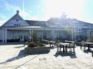 132 Wheelhouse Way, Unit 11 Chester, MD 21619 - Photo 62 of 77 a view of a patio with table and chairs with wooden floor and fence