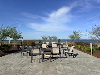 132 Wheelhouse Way, Unit 11 Chester, MD 21619 - Photo 63 of 77 a view of a tables and chairs in patio