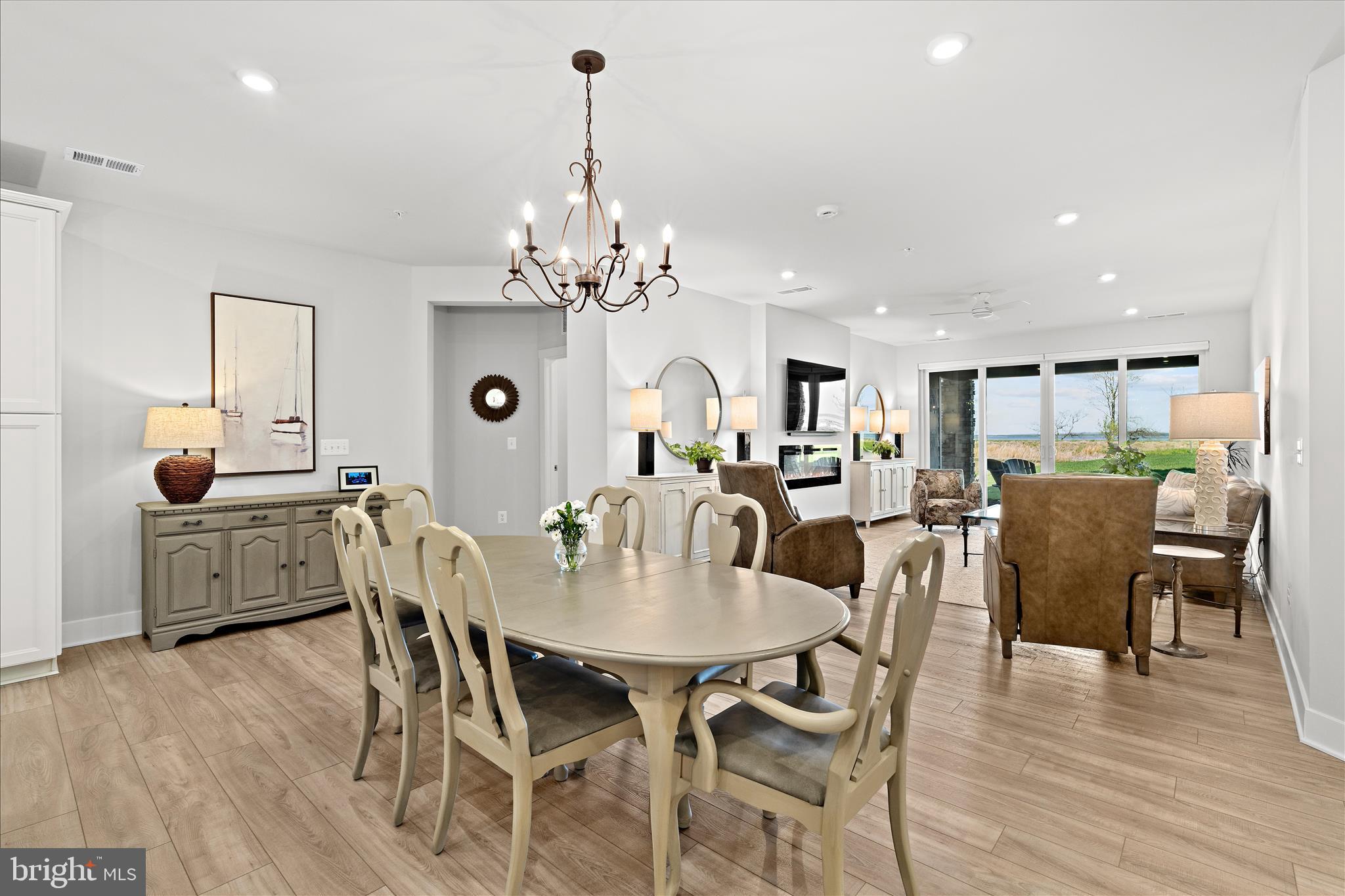 132 Wheelhouse Way, Unit 11 Chester, MD 21619 - Photo 6 of 77 a view of a dining room with furniture wooden floor and chandelier