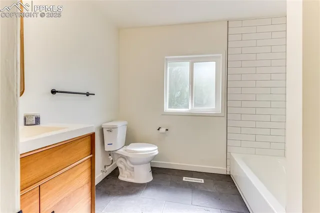 a bathroom with a toilet a sink and a bathtub