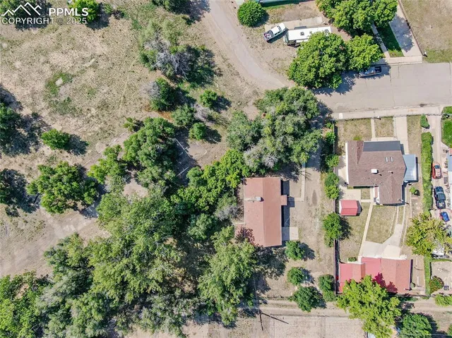 an aerial view of a house with a yard and garden