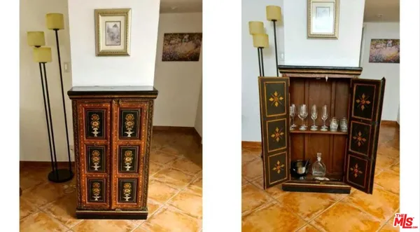 a room with lots of tables a large window and chairs