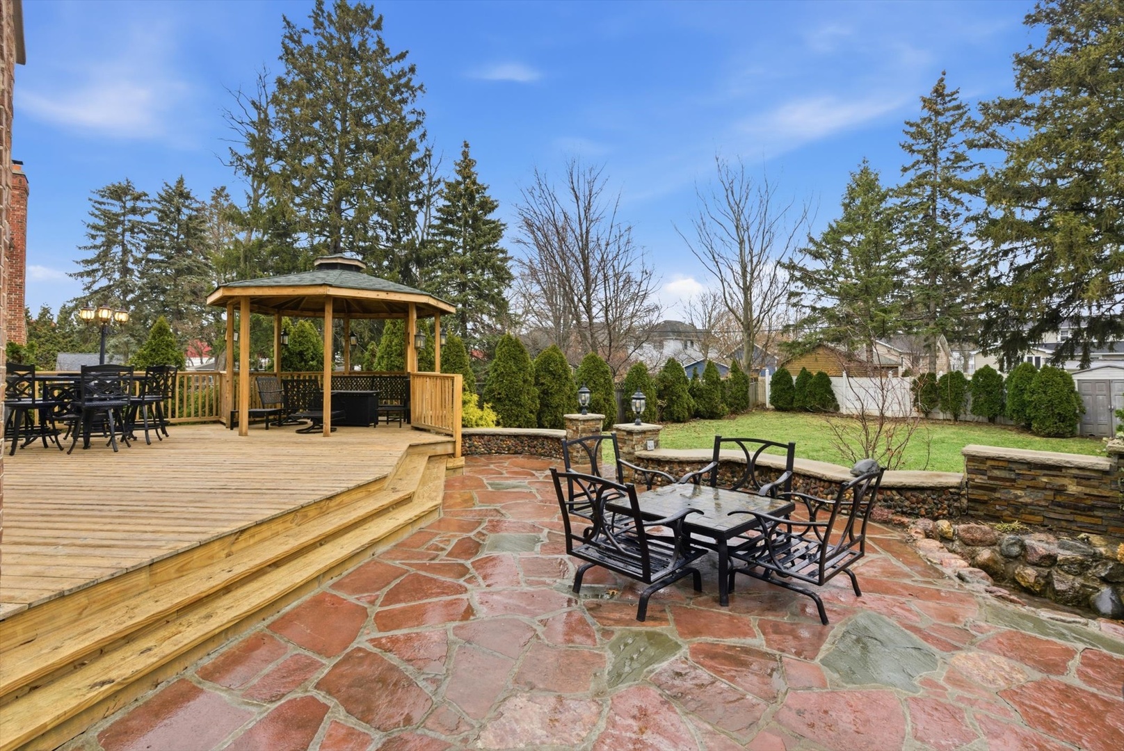 395 Scott Street Elmhurst, IL 60126 - Photo 37 of 46 a view of a patio with a dining table and chairs with a fire pit