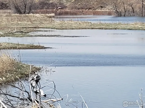 a view of ocean with a floor to ceiling window and outdoor space