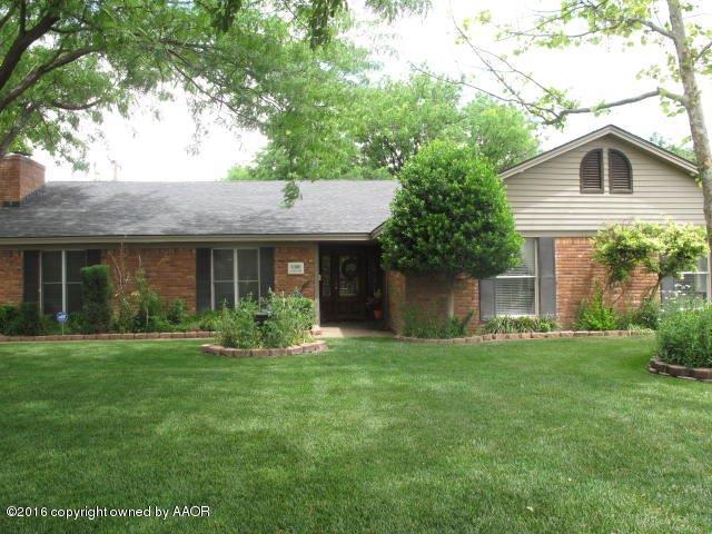 6306 Jameson Road Amarillo, TX 79106 - Photo 1 of 32 a front view of a house with a garden and trees