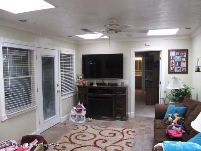 6306 Jameson Road Amarillo, TX 79106 - Photo 14 of 32 a living room with furniture and a flat screen tv