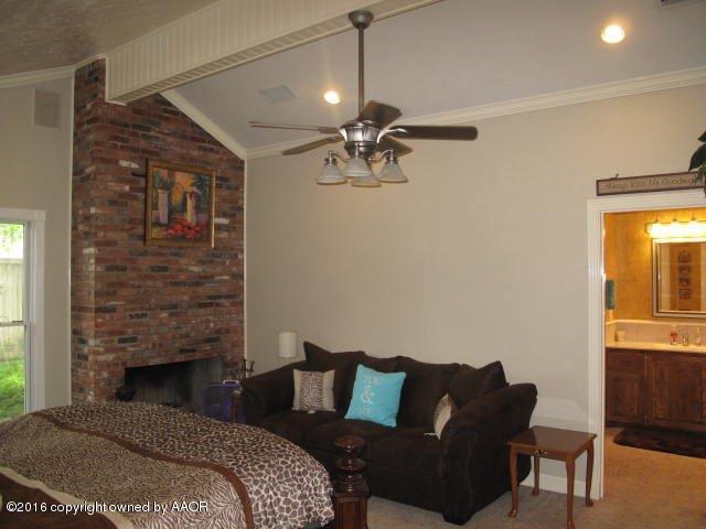 6306 Jameson Road Amarillo, TX 79106 - Photo 15 of 32 a bedroom with a bed and a couch