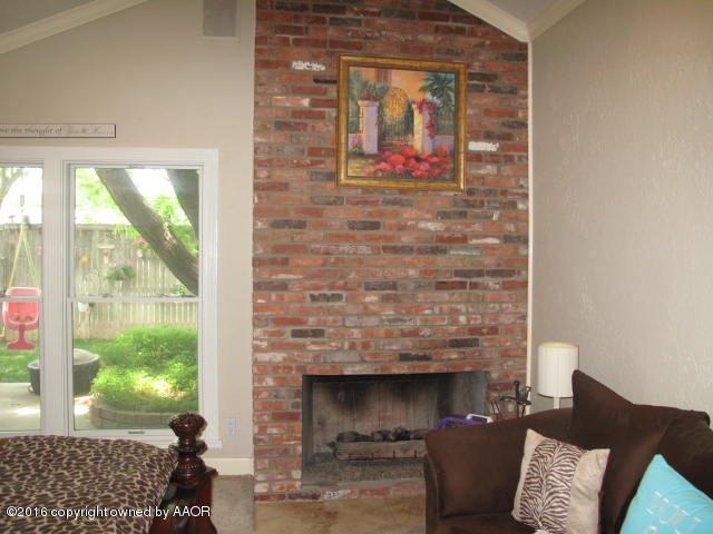 6306 Jameson Road Amarillo, TX 79106 - Photo 16 of 32 a living room with furniture and a fireplace