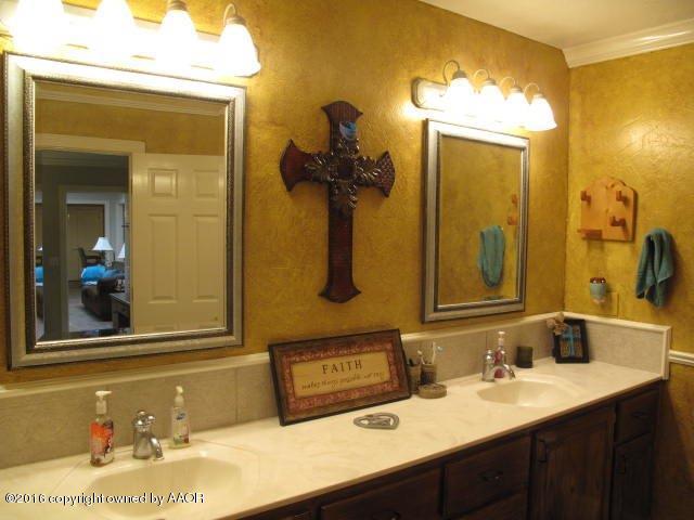 6306 Jameson Road Amarillo, TX 79106 - Photo 18 of 32 a bathroom with a sink and a mirror