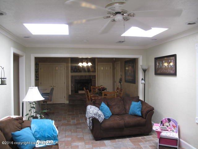 6306 Jameson Road Amarillo, TX 79106 - Photo 24 of 32 a living room with furniture and a chandelier