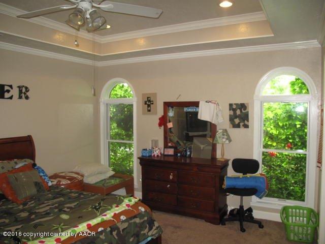 6306 Jameson Road Amarillo, TX 79106 - Photo 31 of 32 a bedroom with a bed and a large window