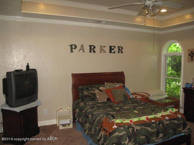6306 Jameson Road Amarillo, TX 79106 - Photo 32 of 32 a bed sitting in a bedroom next to a window