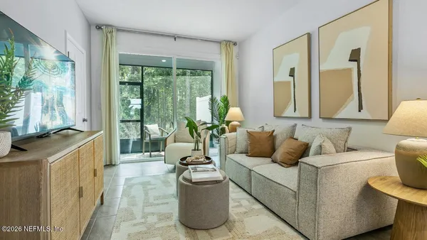 a living room with furniture and a floor to ceiling window