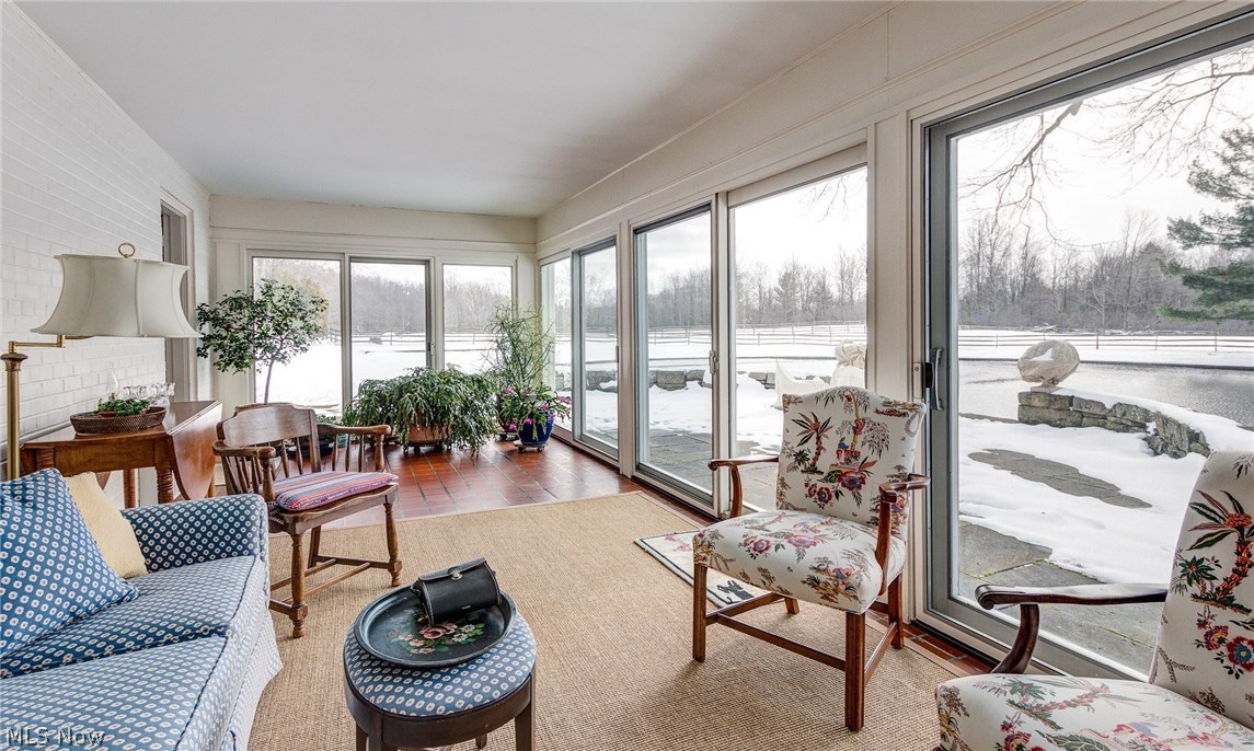 13753 County Line Road Novelty, OH 44072 - Photo 14 of 31 On the south side of the home, the sunroom enjoys the warmth of the the winter sun.