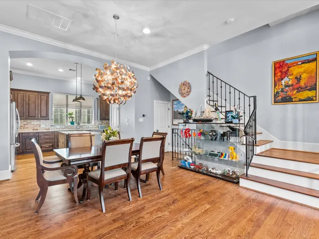a dining room with furniture and wooden floor