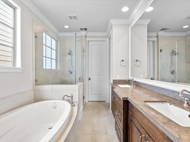 a spacious bathroom with a granite countertop tub sink shower and mirror