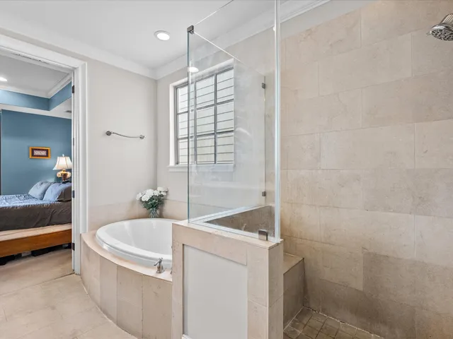 a bathroom with a tub a sink and a shower